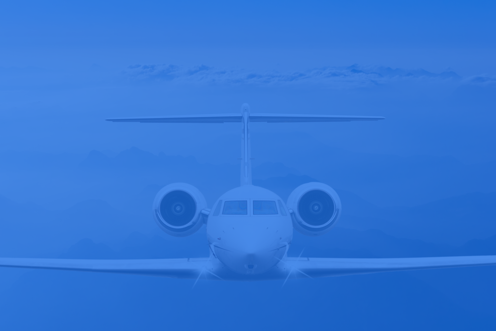 Airplane wing above clouds at sunrise